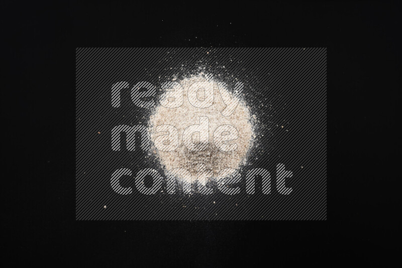 A bunch of onion powder on black background
