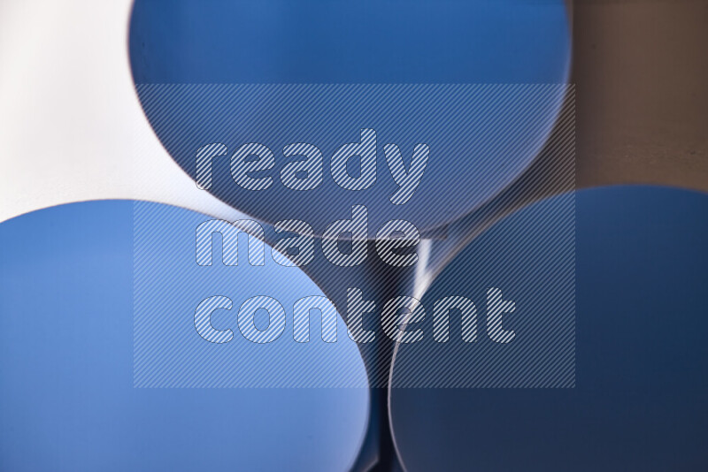 The image shows an abstract paper art with circular shapes in varying shades of blue