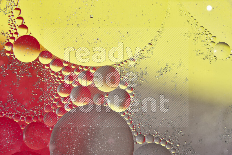 Close-ups of abstract oil bubbles on water surface in shades of yellow, red and brown