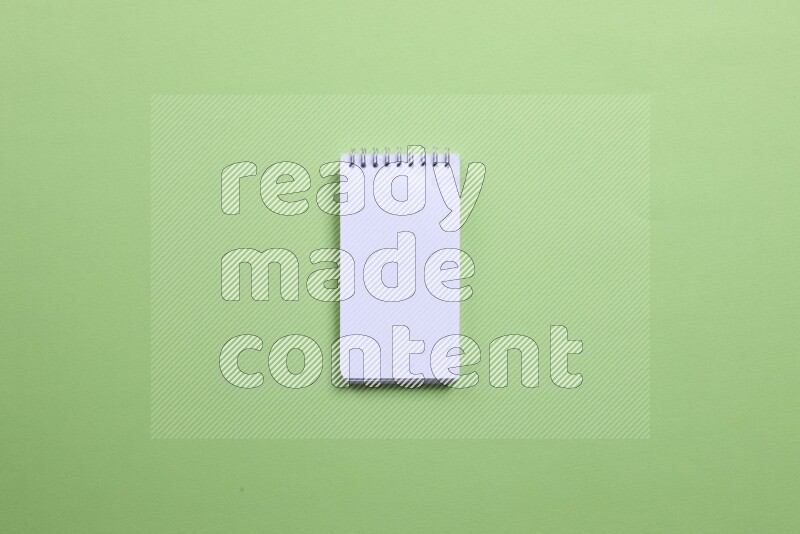 A blank open notebook on green background