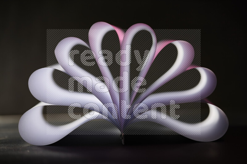 An abstract art piece displaying smooth curves in pink and white gradients created by colored light