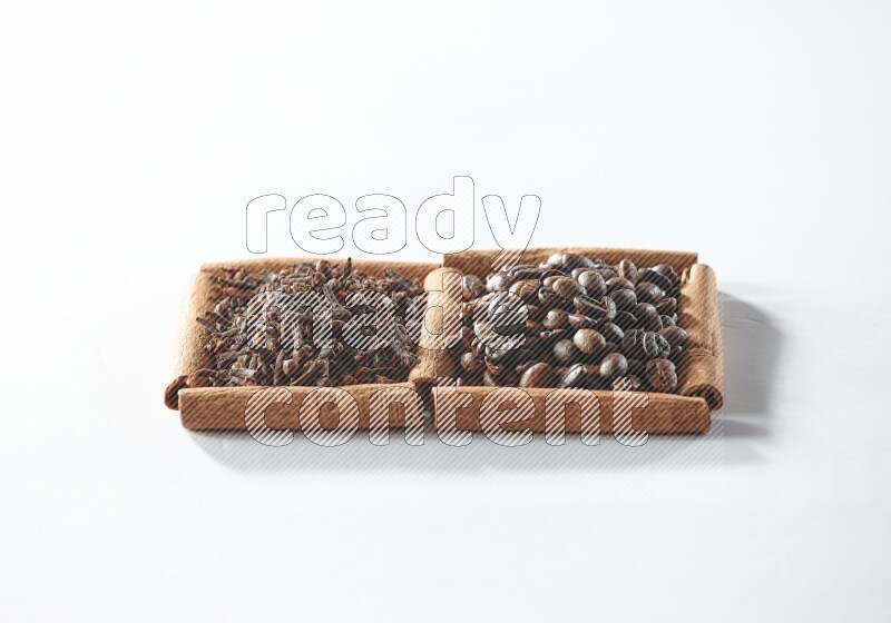 2 squares of cinnamon sticks full of coffee beans and cloves on white flooring