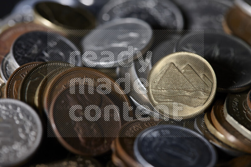 A close-ups of random old coins on black background