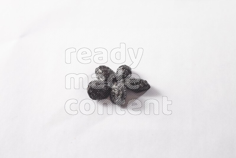 Dried plums on white background