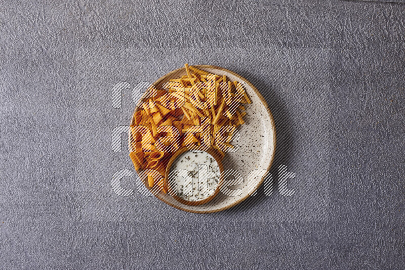 Assorted snacks in pottery bowls on grey background