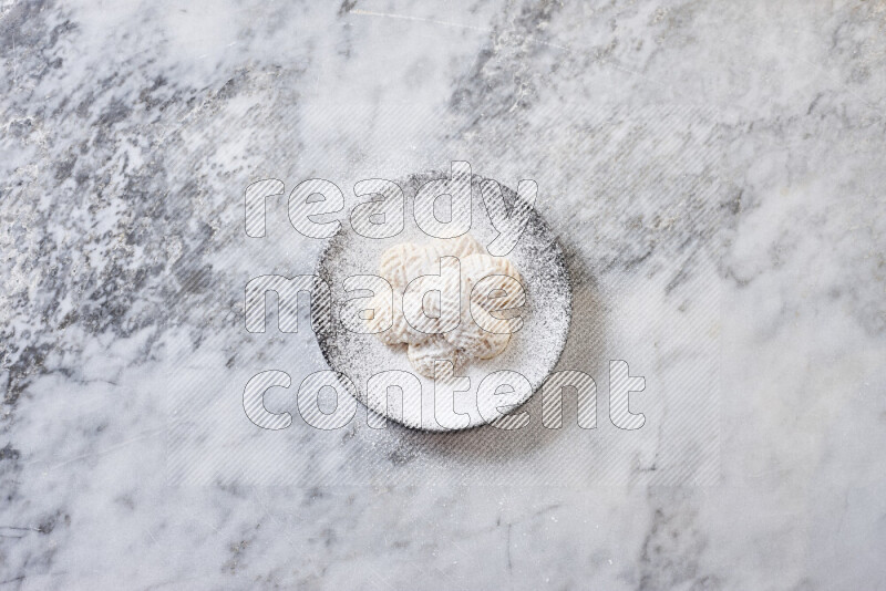 Kahk in black pottery plate on grey marble background