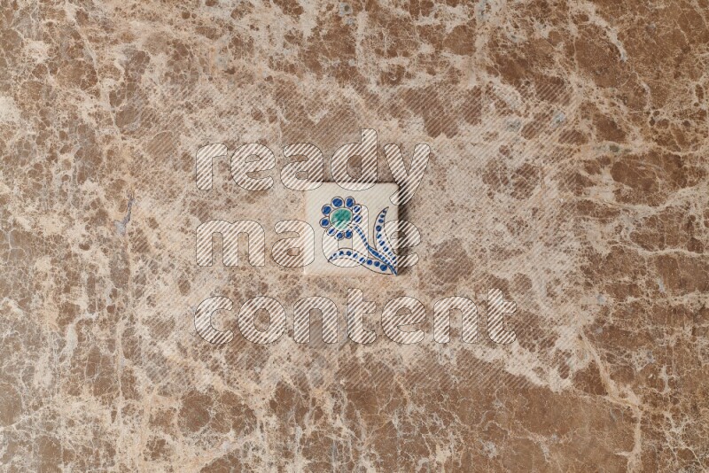 A decorative coaster on beige marble background