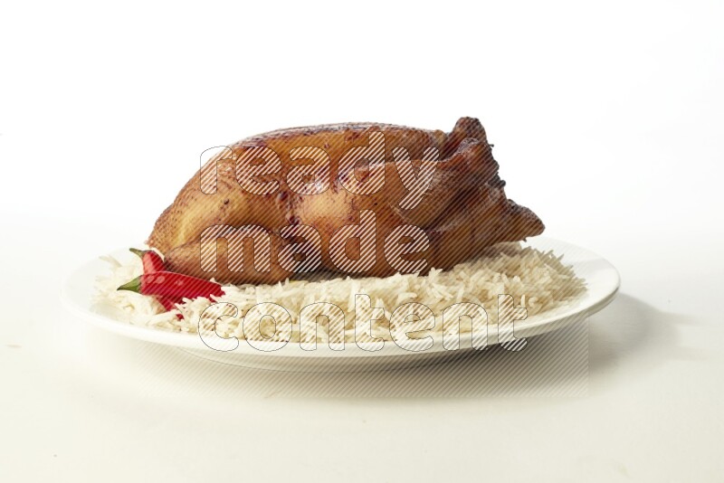white  basmati Rice with  whole roasted chicken  on a white rounded plate direct on white background
