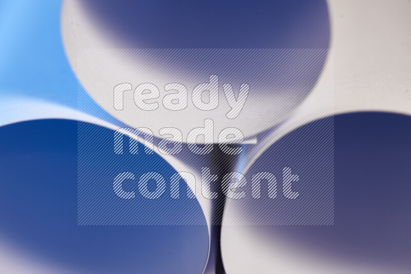 The image shows an abstract paper art with circular shapes in varying shades of blue