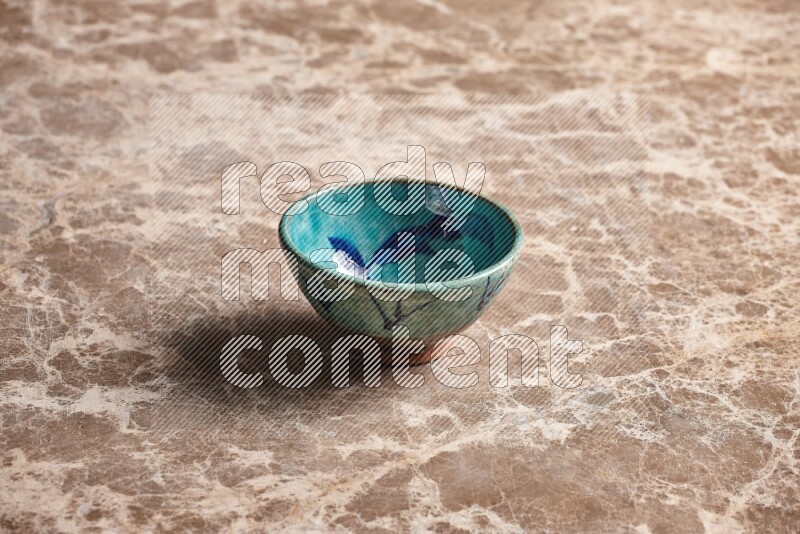 A decorative pottery bowl on beige marble background