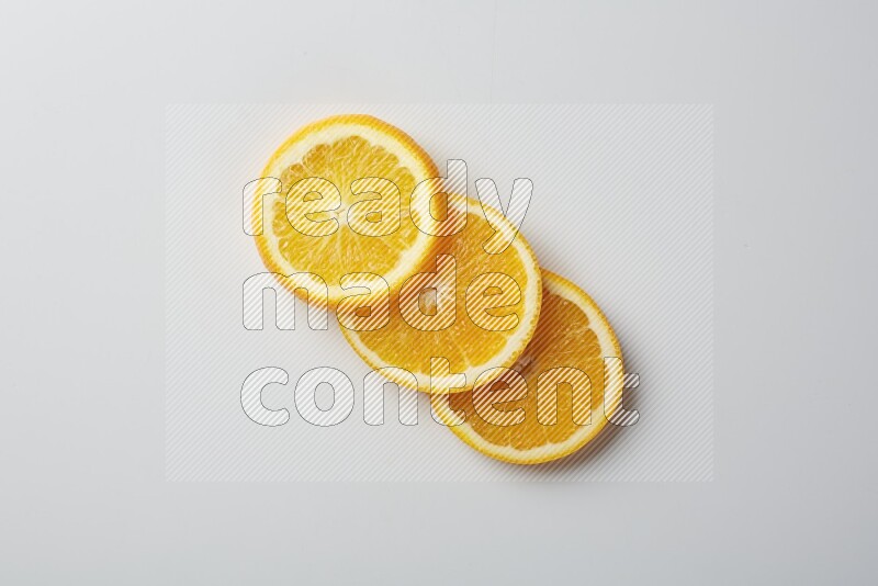Three orange slices on a white background