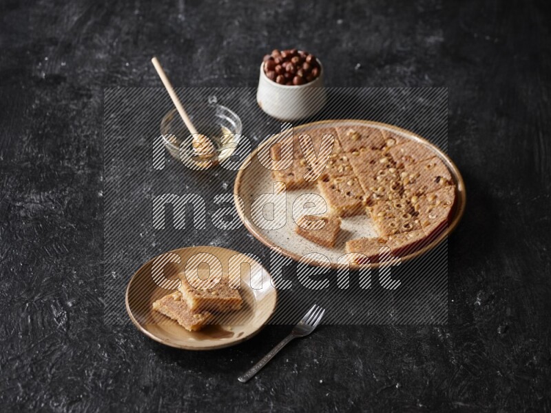 Basbousa with nuts and honey in a dark setup