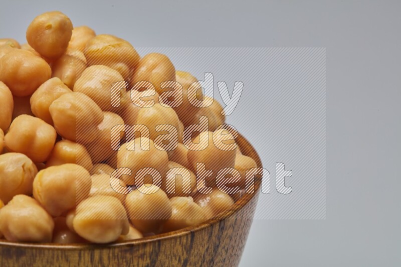 Close up shot of boiled chickpeas in a container on white background