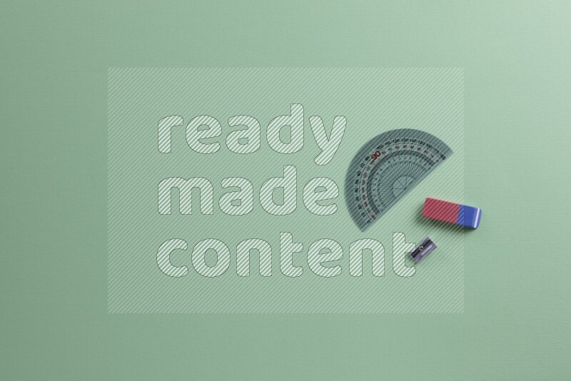 Different school supplies on green background