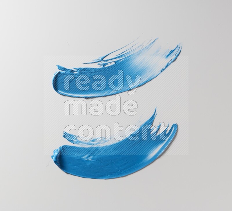 Blue curved painting knife strokes on white background