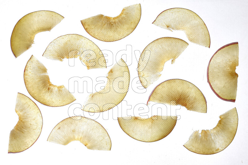 Peach slices on illuminated white background