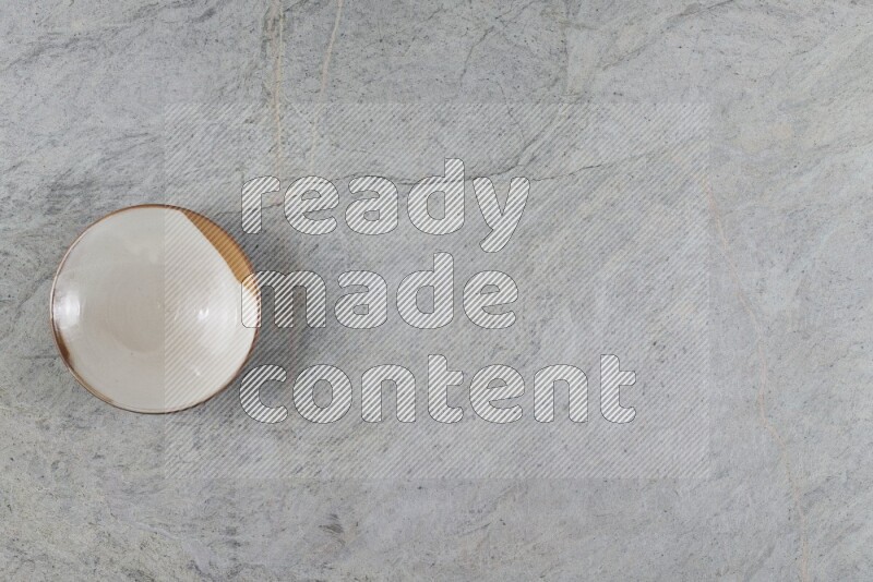 A multicolored pottery plate on grey marble background