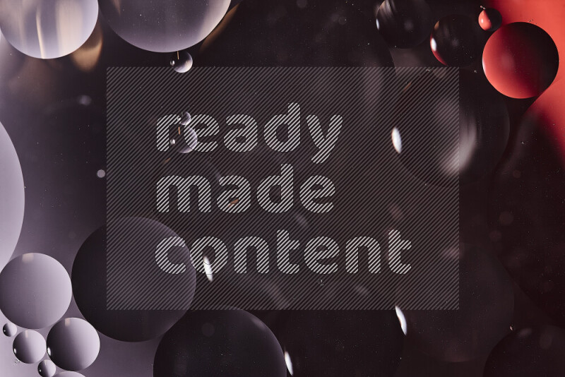 Close-ups of abstract oil bubbles on water surface in shades of black and red