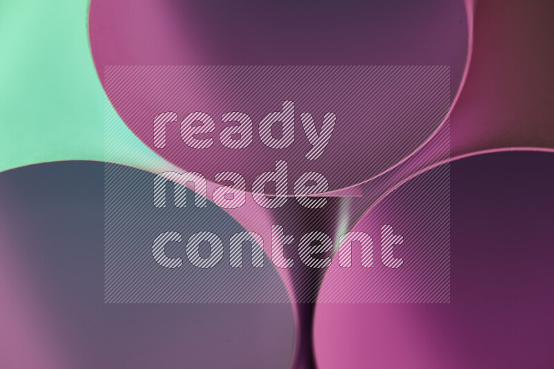 The image shows an abstract paper art with circular shapes in varying shades of green and purple