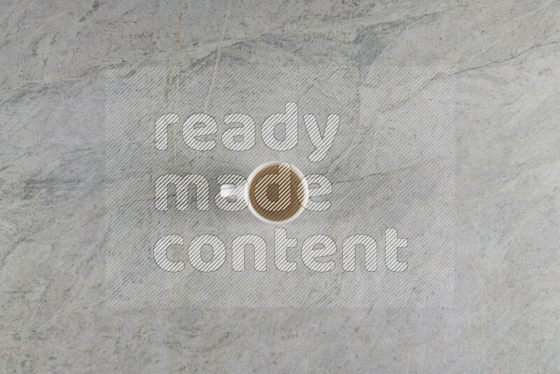 A multicolored pottery Cup on grey marble background