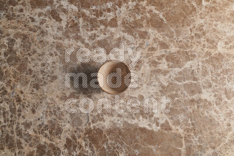 A pottery cup on beige marble background