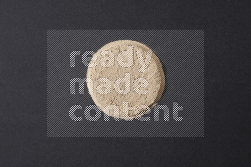 Garlic powder in a circle shape on a black flooring