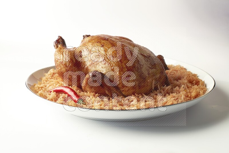 red basmati Rice with whole roasted chicken on a white plate with a silver rim direct on white background