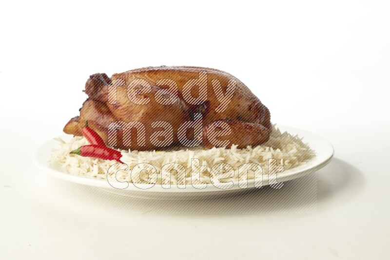 white  basmati Rice with  whole roasted chicken  on a white rounded plate direct on white background