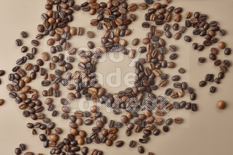 Roasted coffee beans on beige background