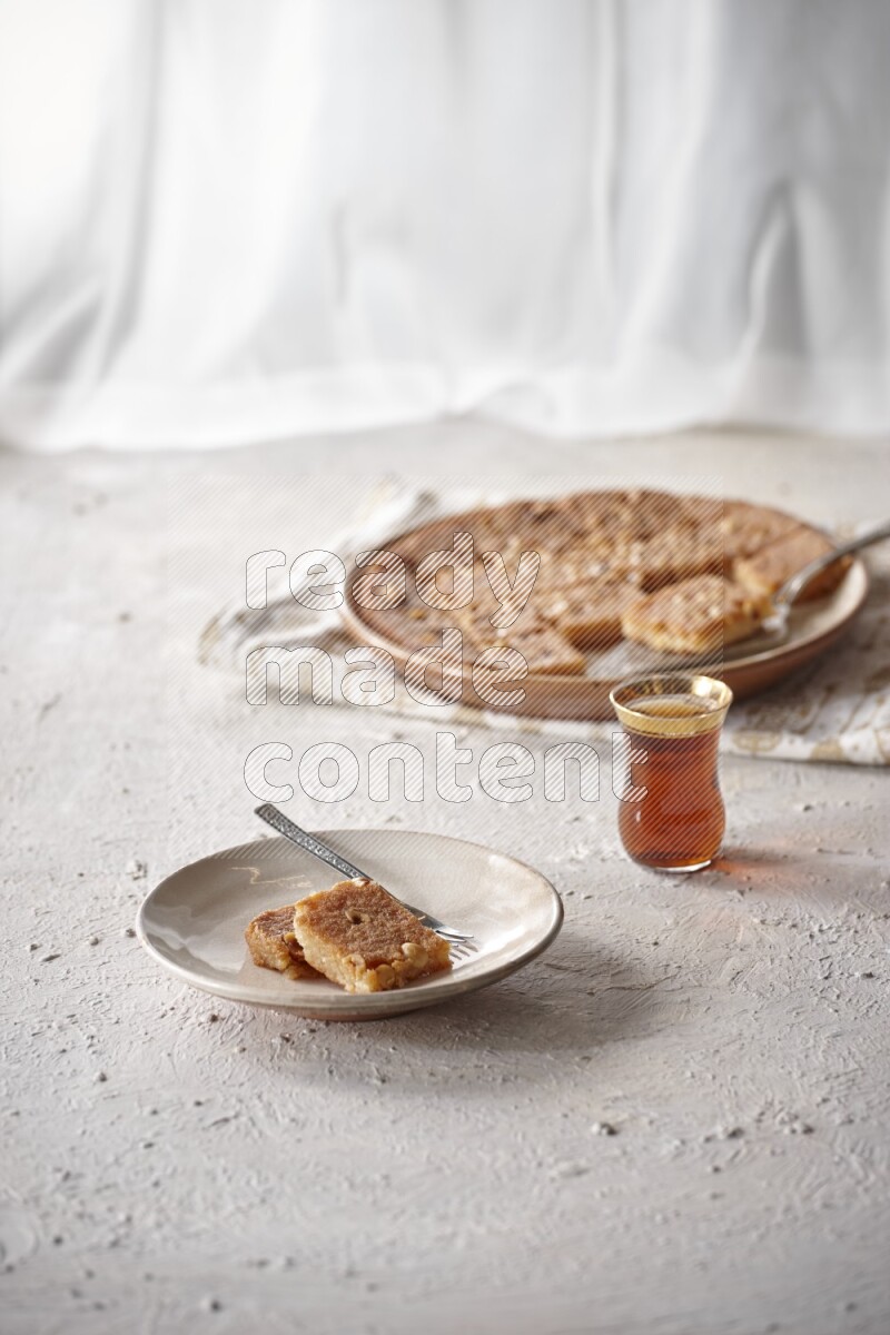 Basbousa with tea in a light setup
