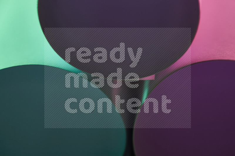 The image shows an abstract paper art with circular shapes in varying shades of green and purple