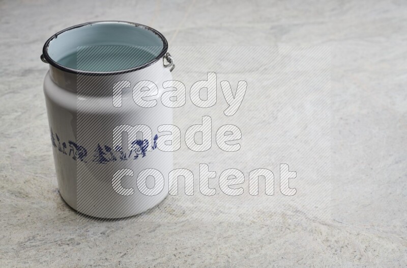 A vintage milk can on grey marble background