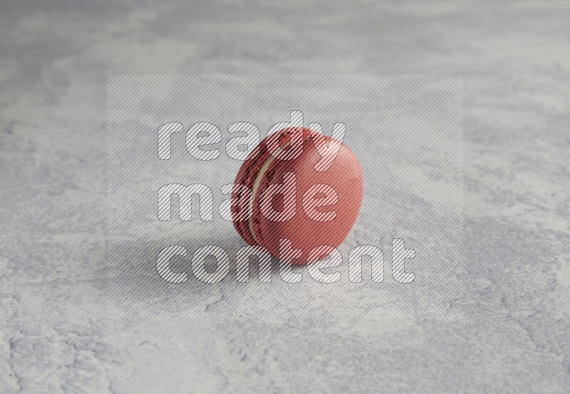 45º Shot of Red Velvet macaron on white  marble background