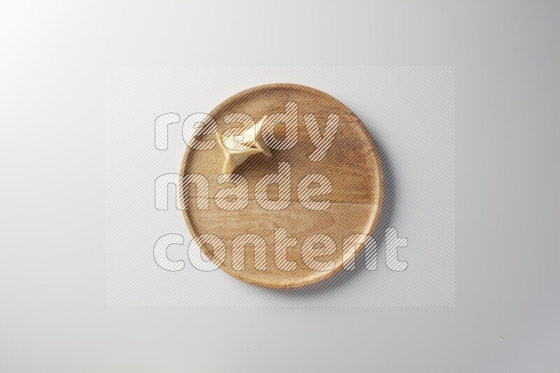 Two Sambosas on a wooden round plate on a white background