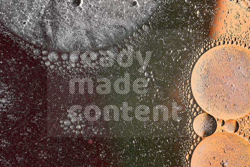 Close-ups of abstract oil bubbles on water surface in shades of orange, green and red
