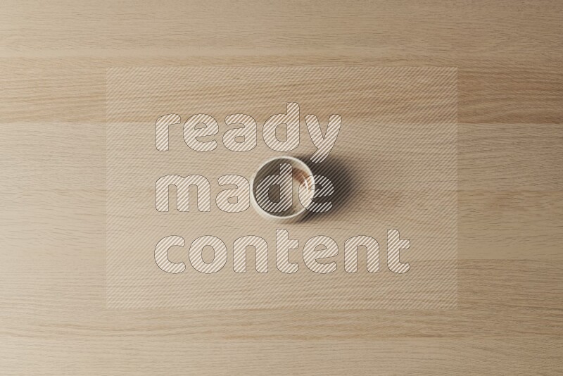 A pottery cup on light wooden background