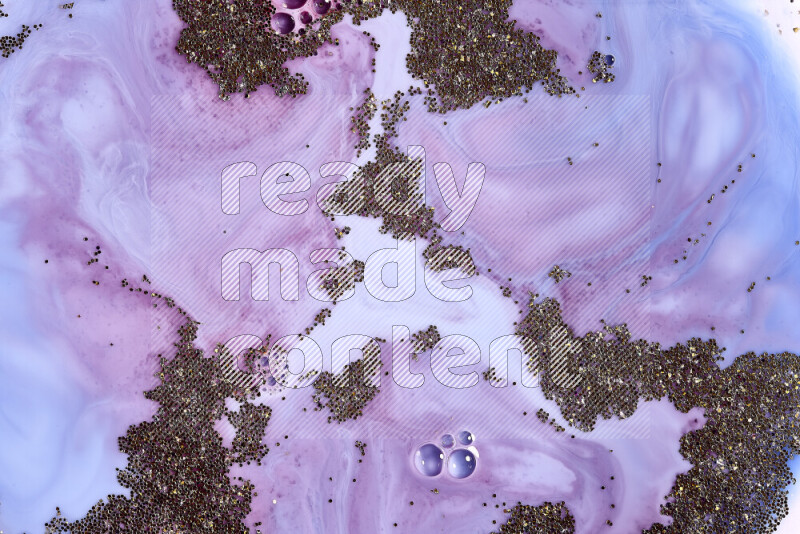 لقطة مقربة لبريق ذهبي متلألئ منتشر على خلفية من اللون الأزرق والأحمر في حركات دائرية