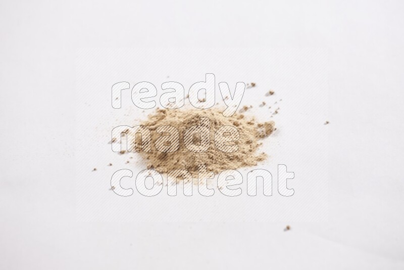 A small pile of garlic powder on a white background
