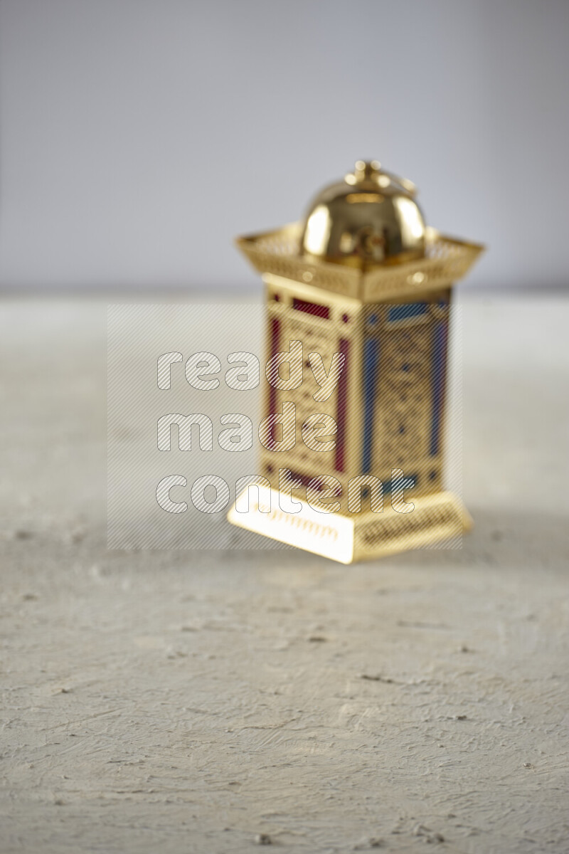 A lantern placed on a textured white background