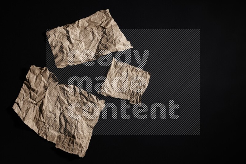 Crumpled craft paper on black background
