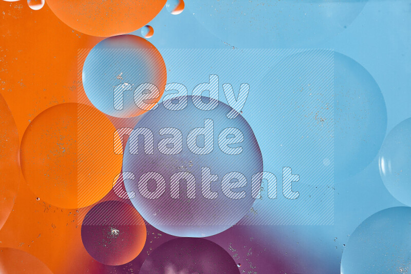 Close-ups of abstract oil bubbles on water surface in shades of blue, orange and purple