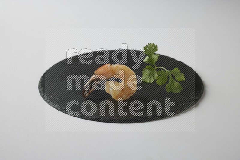 one  grilled shrimp  on a black slate direct  on a white back ground