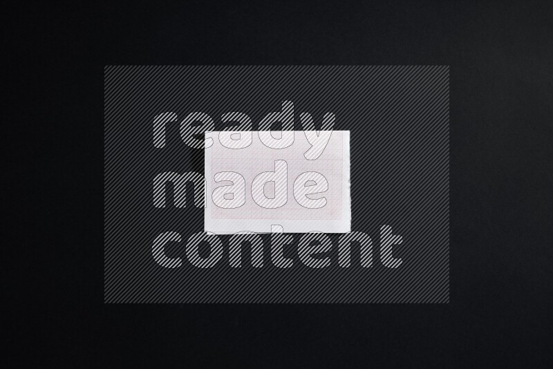 Folded notebook sheet on black background