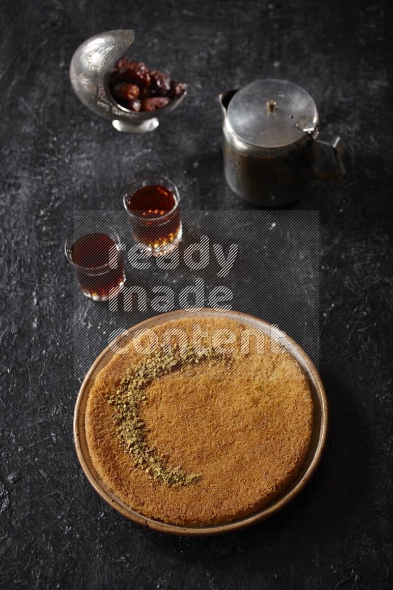 konafa with tea in a dark setup