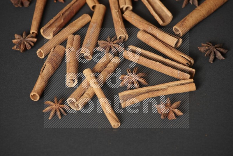 Cinnamon sticks and star anise on black background