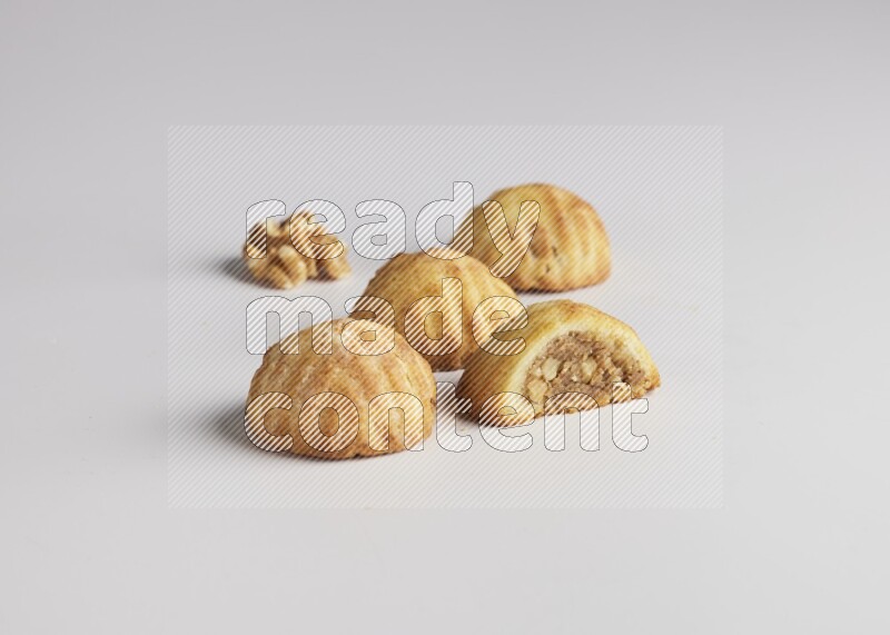 Four Pieces of Maamoul filled with walnut paste  one of them is cut direct on white background