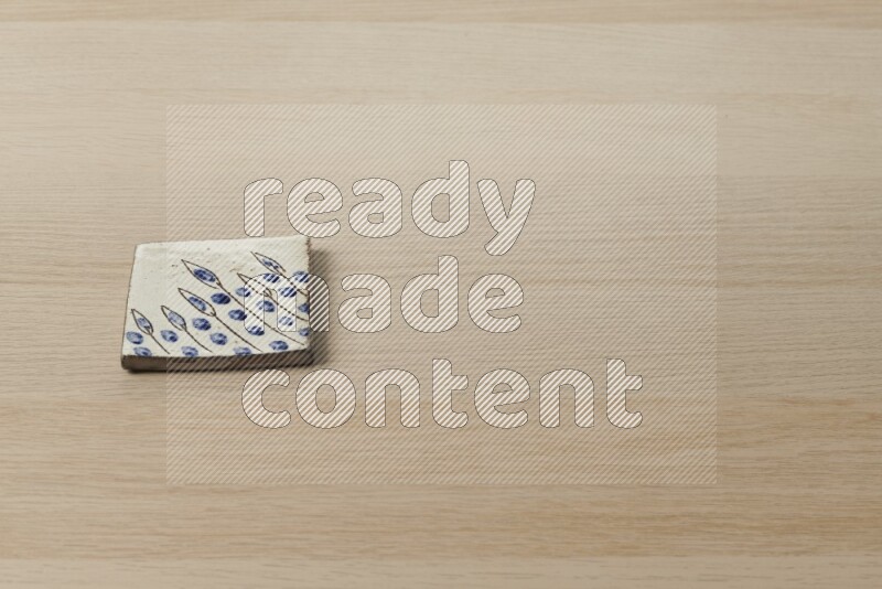 A decorative coaster on light wooden background