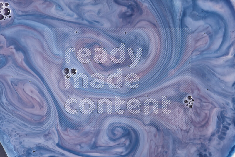 A close-up of abstract swirling patterns in blue, red and white