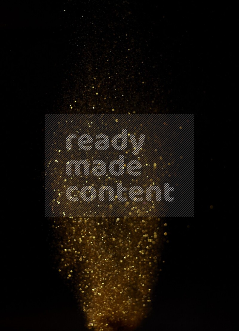 Gold glitter powder isolated on black background
