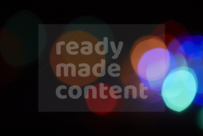 Light bulbs glowing against backdrop of multicolord bokeh